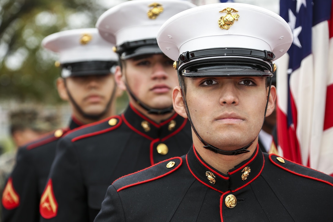 Marines look straight ahead during a ceremony.