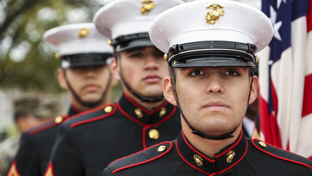 Marines look straight ahead during a ceremony.