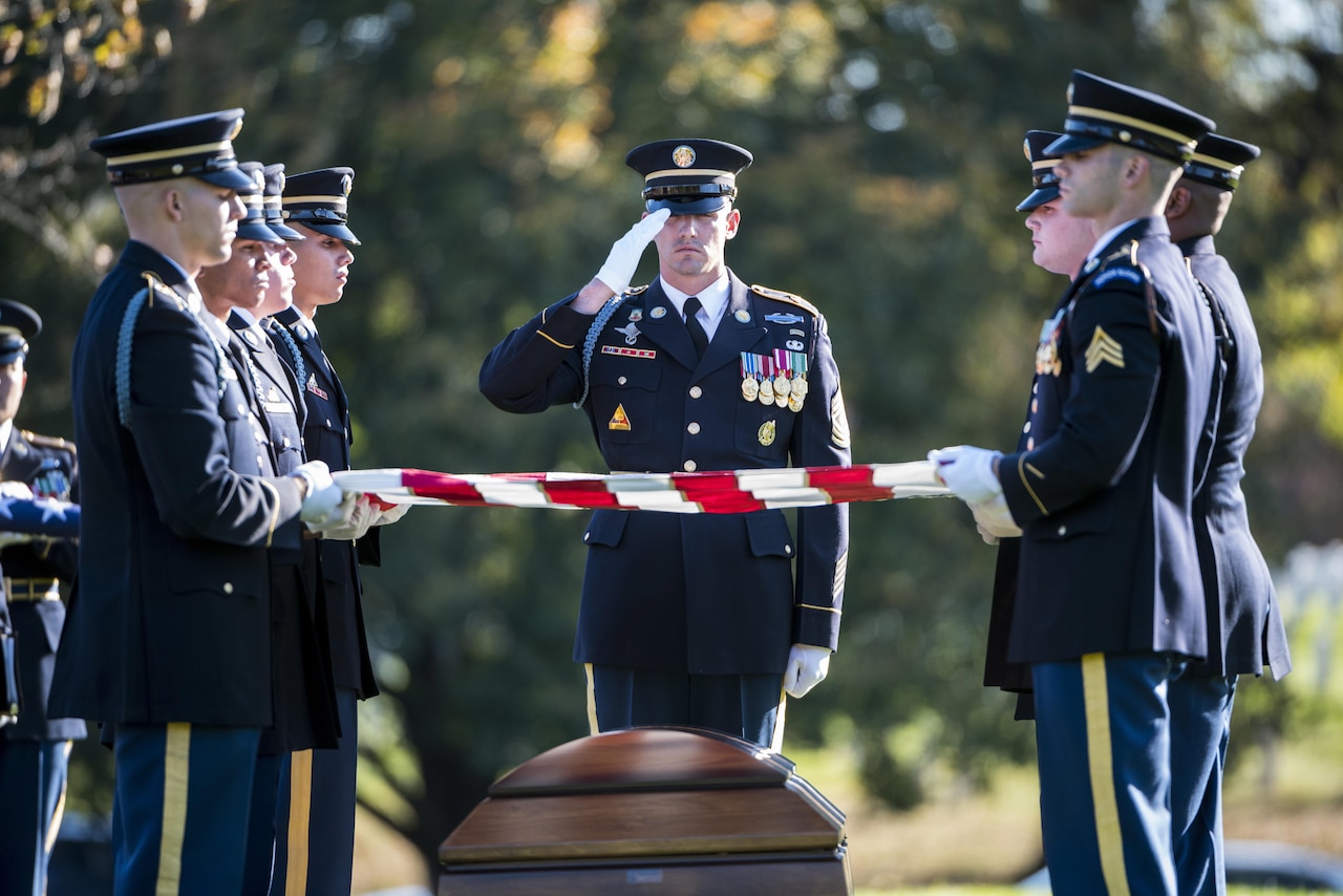Soldiers fold the flag at a funeral