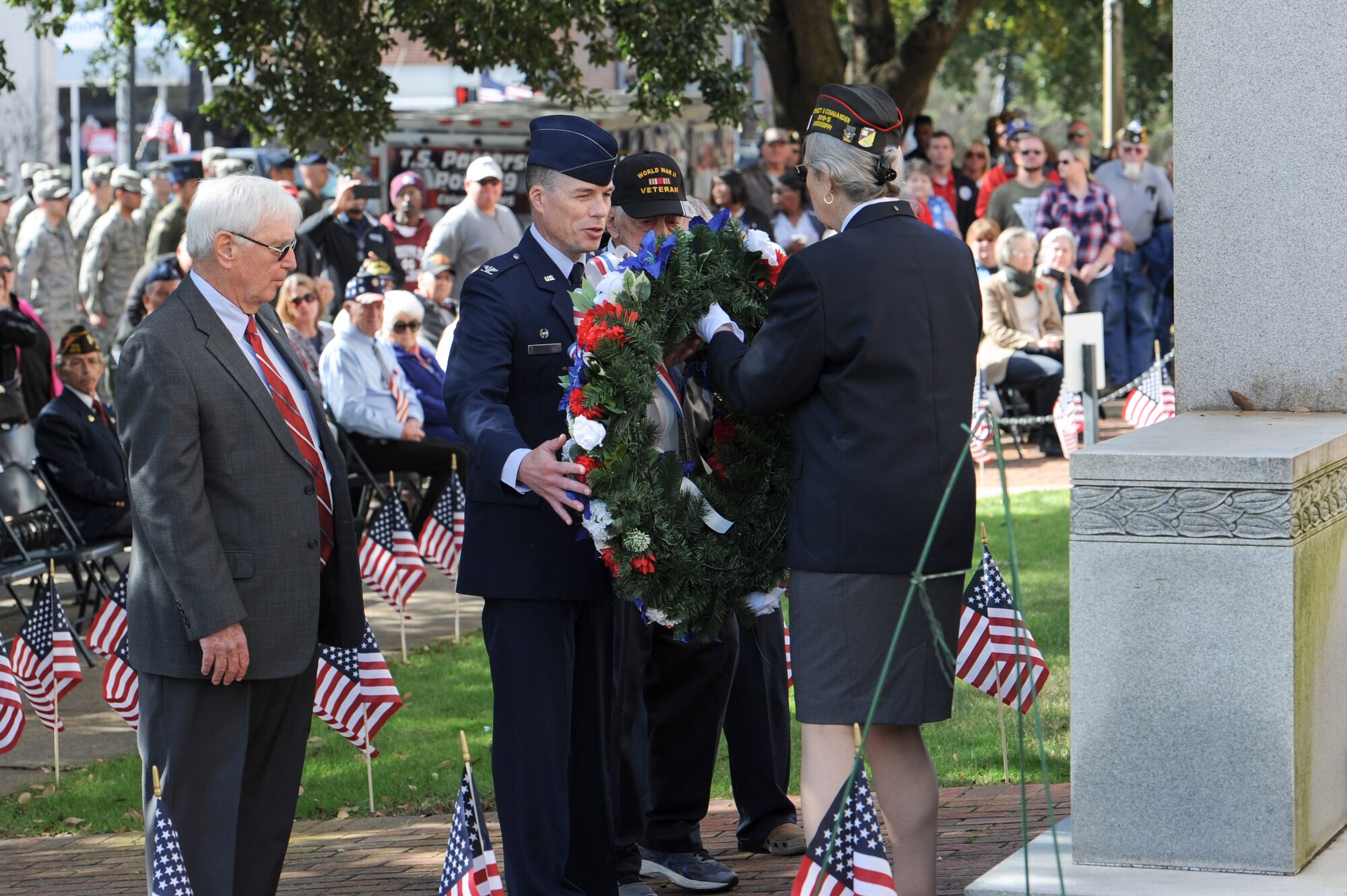 Maggy Wesley, Veterans of Foreign Wars District 8 Commander, hands Col. Douglas Gosney, 14th Flying Training Wing Commander, Columbus Vice Mayor Bill Gavin, former Spc. Roy Fuqua and Supervisor Harry Sanders a wreath during a Veterans Day ceremony at the Lowndes County Courthouse Nov. 11, 2017, in Columbus, Mississippi. Members of Columbus AFB and the city of Columbus came together to organize a parade and ceremony to honor veterans. (U.S. Air Force photo by Staff Sgt. Christopher Gross)