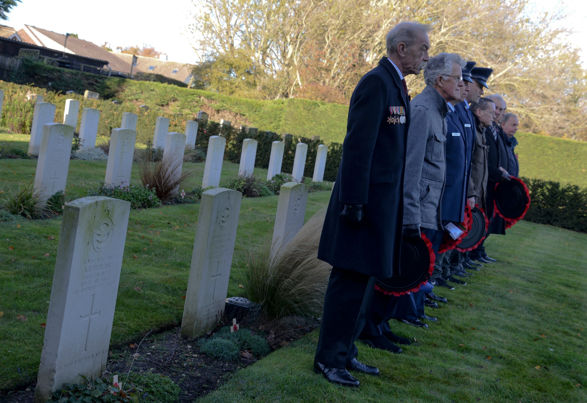 U.S. Airmen from RAF Mildenhall and local representatives prepare to lay wreaths of poppies on the St. John’s Church War Graves Memorial in Beck Row, England, Nov. 12, 2017.  The red flowers were chosen as the symbol of Remembrance Day to commemorate the lives lost in the poppy fields of Flanders, Belgium, during World War I. (U.S. Air Force photo by Senior Airman Justine Rho)