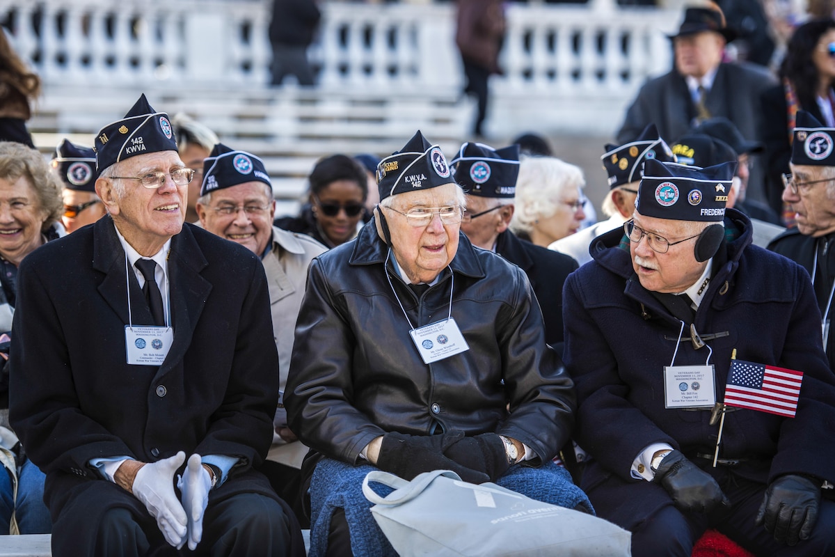 Veterans sit at the Memorial Amphitheater.