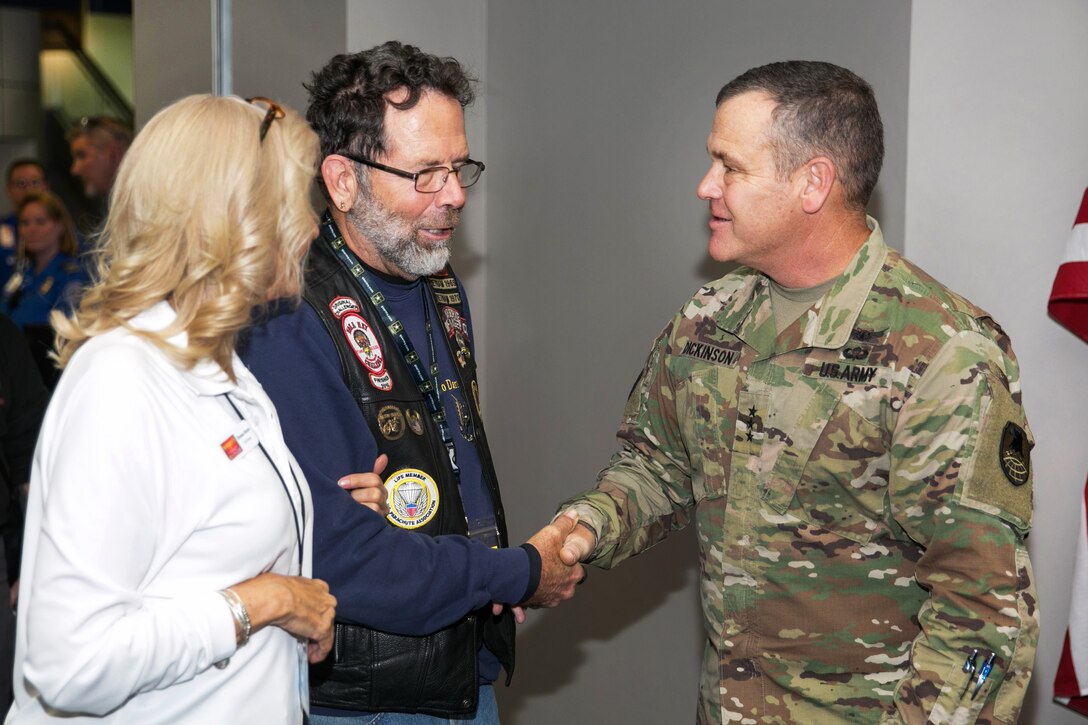 A general shakes hands and welcomes a wounded warrior.