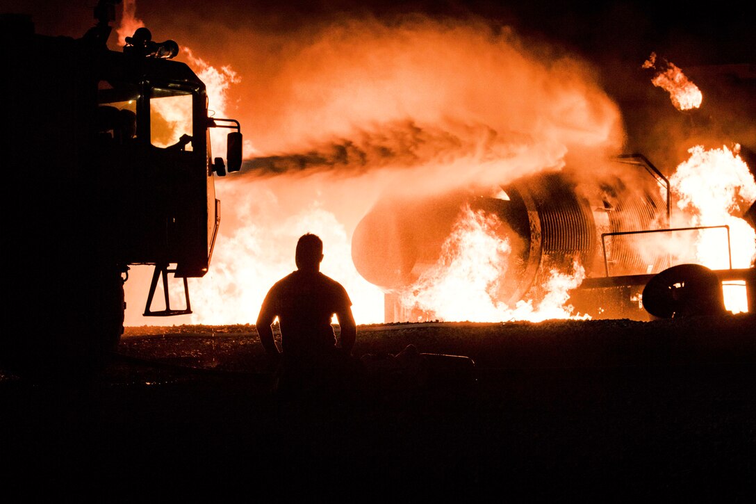 Water shoots out of a firetruck turret during firefighting training at Moody Air Force Base.