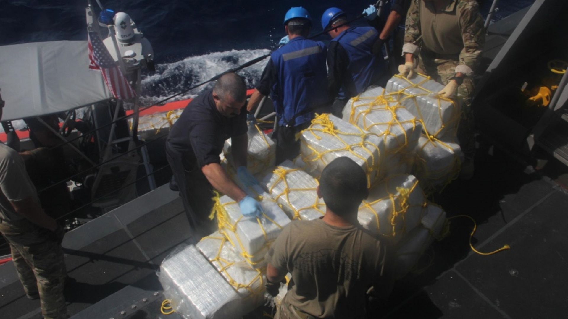 Sailors stack bales of seized cocaine aboard USS Zephyr.