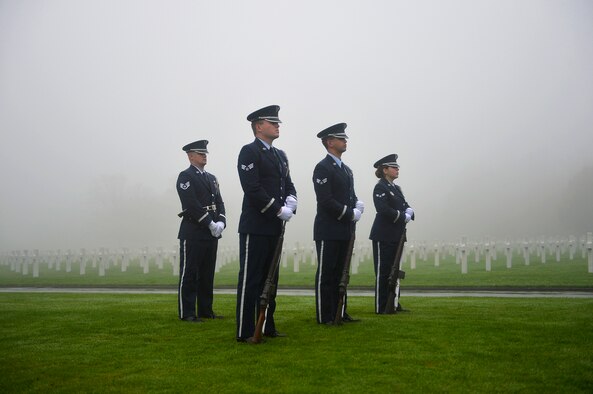 Members of an Air Force honor guard team stand in formation during a Veterans Day ceremony at Henri-Chapelle American Cemetery and Memorial, Belgium, Nov. 11, 2017. The team conducted a hereditary nine gun salute which historically signifies an end to hostilities for a period of time. (U.S. Air Force photo by Airman 1st Class Joshua Magbanua)