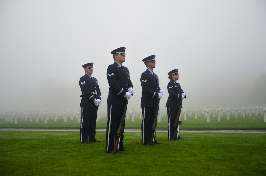 Members of an Air Force honor guard team stand in formation during a Veterans Day ceremony at Henri-Chapelle American Cemetery and Memorial, Belgium, Nov. 11, 2017. The team conducted a hereditary nine gun salute which historically signifies an end to hostilities for a period of time. (U.S. Air Force photo by Airman 1st Class Joshua Magbanua)