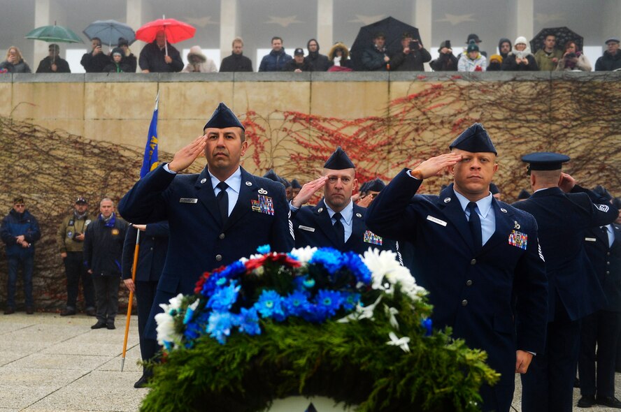 U.S. Air Force Airmen assigned to the 86th Civil Engineer Squadron salute after laying a wreath during a Veterans Day ceremony at Henri-Chapelle American Cemetery and Memorial, Belgium, Nov. 11, 2017. Besides wreath-layings, the ceremony included speeches from distinguished visitors and a hereditary nine gun salute. (U.S. Air Force photo by Airman 1st Class Joshua Magbanua)