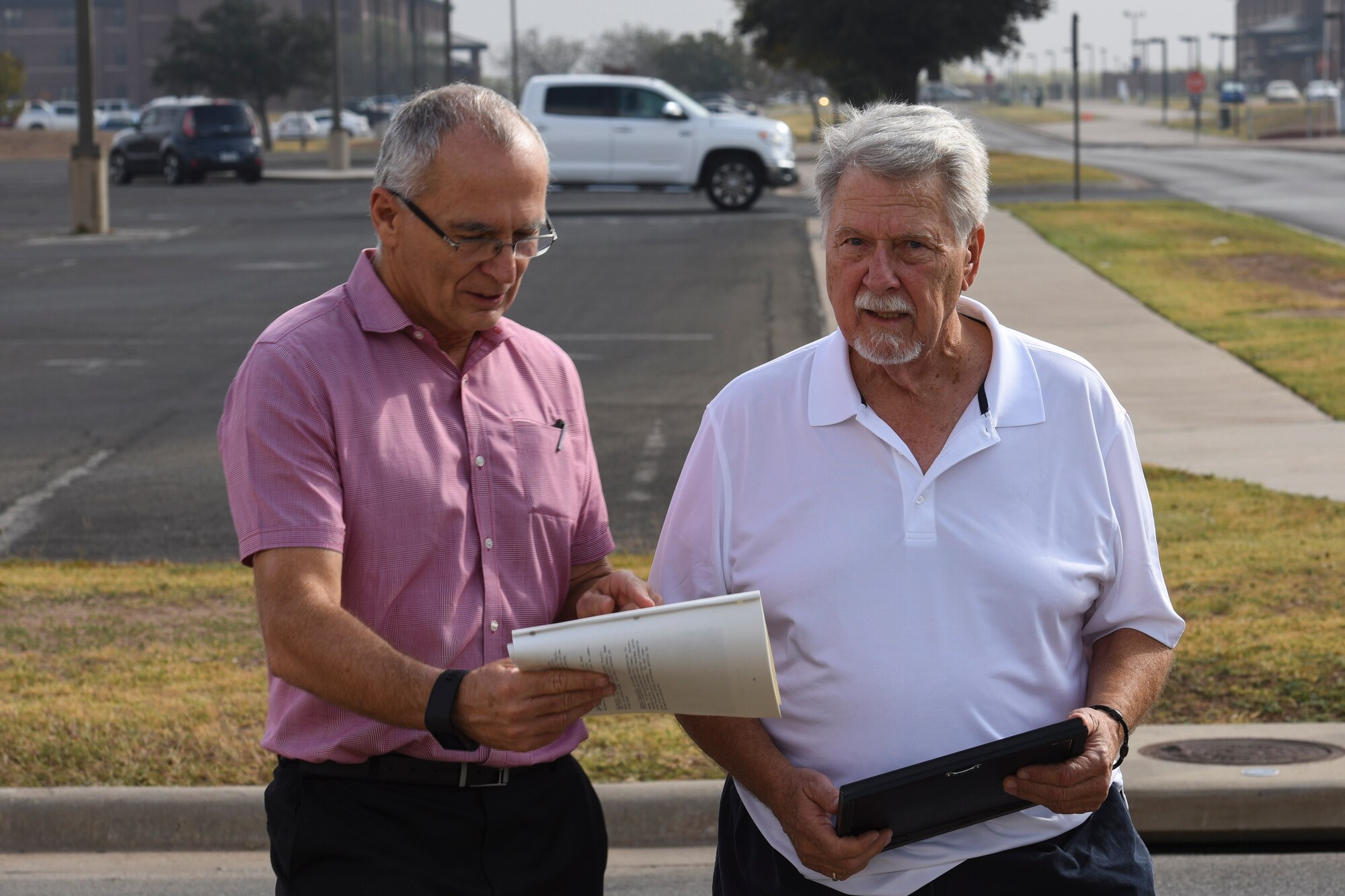 John Garrett, 17th Training Wing historian, shows the changes that the base has undergone since Ron Cichon’s family was stationed here at Goodfellow Air Force Base, Texas, Nov. 6, 2017. Cichon visited to fulfill his mother’s final wish, spreading her ashes on Goodfellow. (U.S. Air Force photo by Airman 1st Class Zachary Chapman/Released)