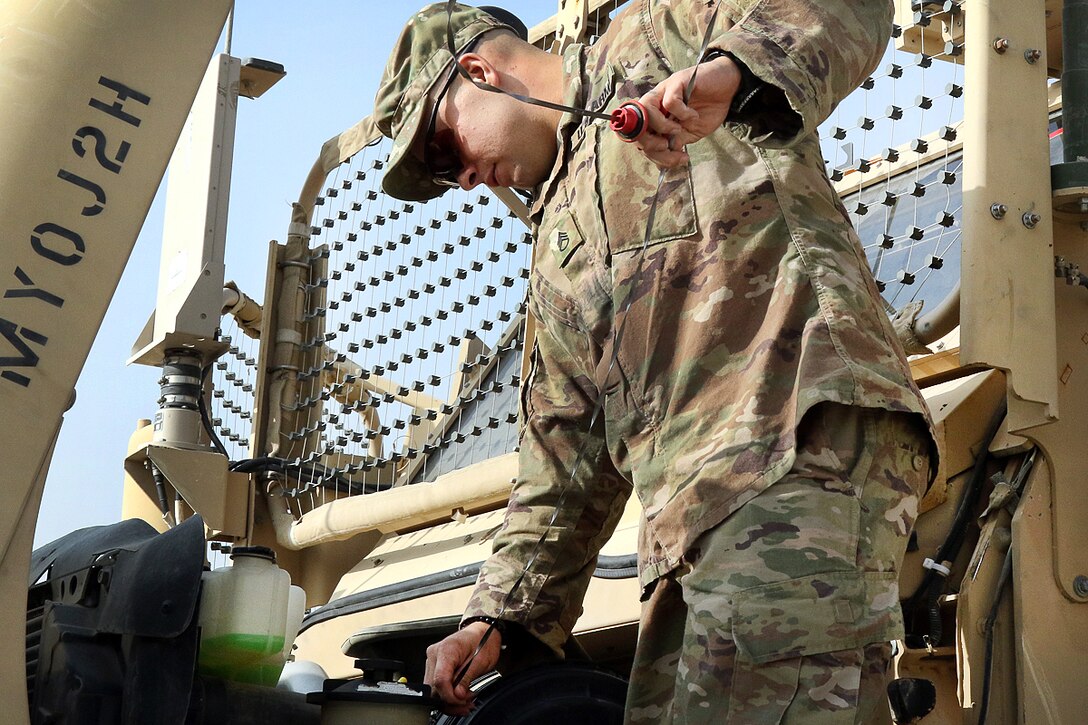 Staff Sgt. Joseph Presher performs preventive maintenance checks on a vehicle during a master driver training course.