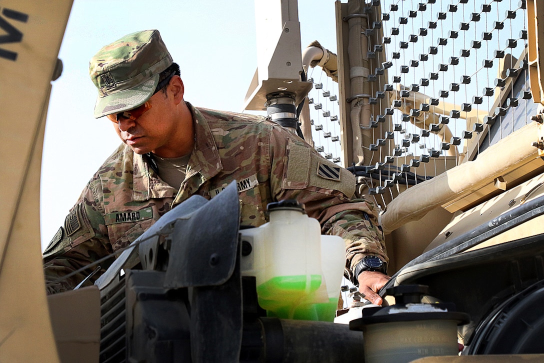 Staff Sgt. Arturo Amaro checks fluid levels in a mine-resistant, ambush-protected vehicle during a master driver training course.