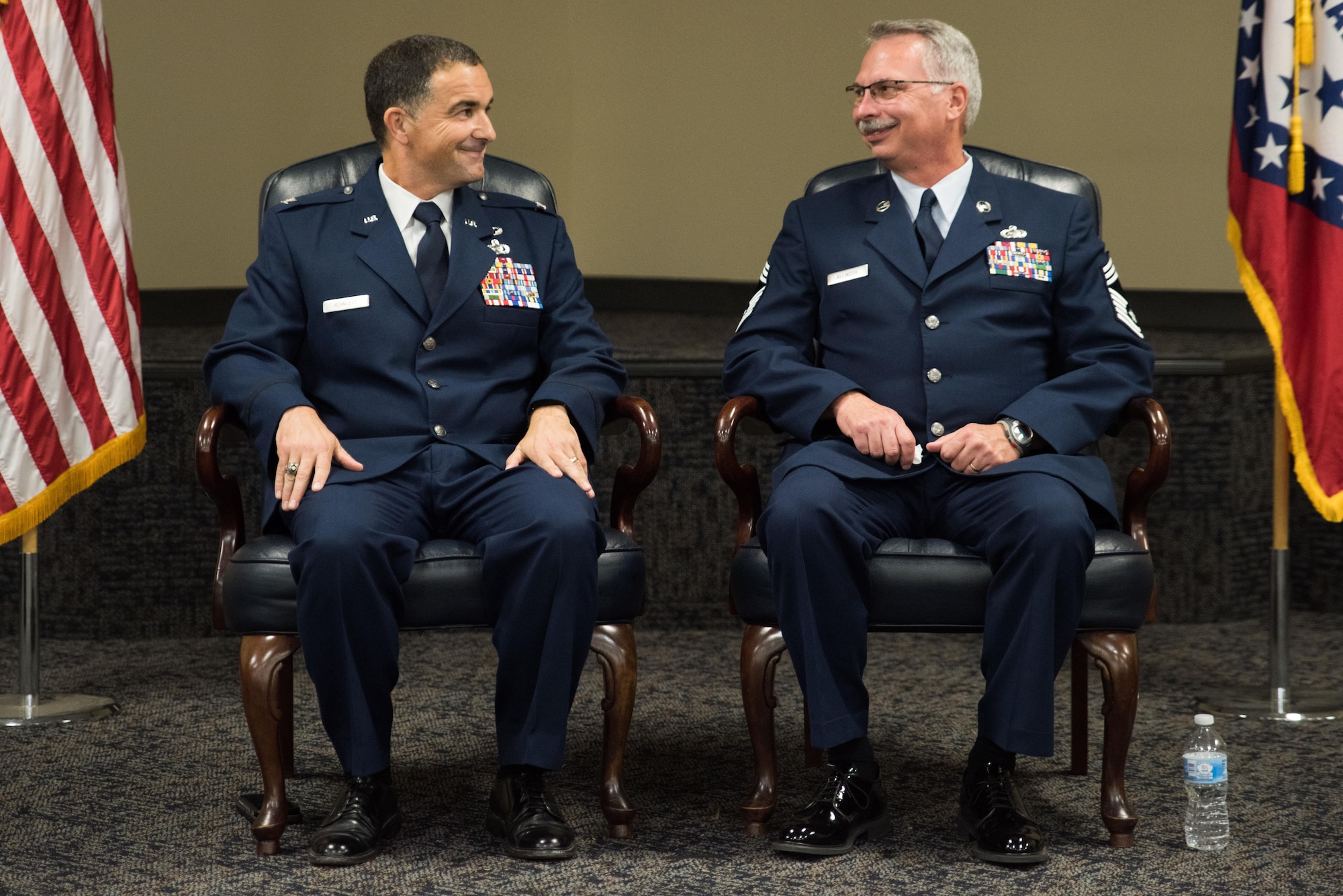 Senior Master Sgt. James Rivers, Superintendent 123rd Intelligence Squadron, presents Chief Master Sgt. Tomi Allinder with a commiserative rifle during his retirement ceremony, Fort Smith, Ark. Allinder served 33 years in the Arkansas Air National Guard’s 123rd Intelligence Squadron before retiring as superintendent, Nov. 04, 2017. (U.S. Air National Guard photo by Tech. Sgt. Daniel Condit)