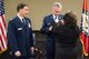 Senior Master Sgt. James Rivers, Superintendent 123rd Intelligence Squadron, presents Chief Master Sgt. Tomi Allinder with a commiserative rifle during his retirement ceremony, Fort Smith, Ark. Allinder served 33 years in the Arkansas Air National Guard’s 123rd Intelligence Squadron before retiring as superintendent, Nov. 04, 2017. (U.S. Air National Guard photo by Tech. Sgt. Daniel Condit)