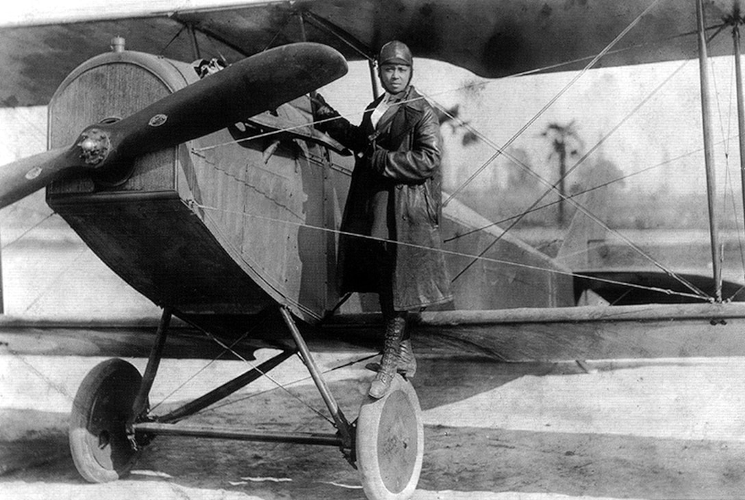 Bessie Coleman stands on the wing of a World War I surplus Curtis JN-4 Jenny in an image thought to have been taken not long after journeyaing to France where she became the first African American woman to earn a pilot’s license.