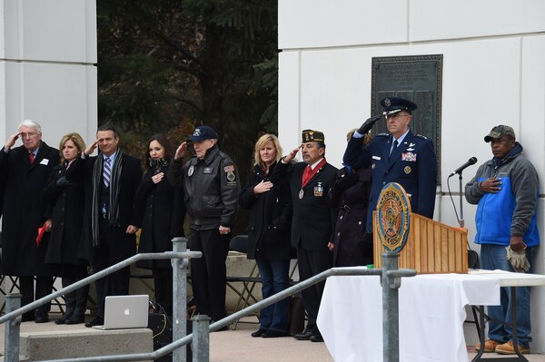 U.S. Air Force Gen. John Hyten, commander of U.S. Strategic Command, and other distinguished guests pay respects to the United States flag during a Veterans Day ceremony at Memorial Park in Omaha, Neb., Nov. 11, 2017. More than 200 people attended the ceremony to honor the service and sacrifice of American veterans and their families.
