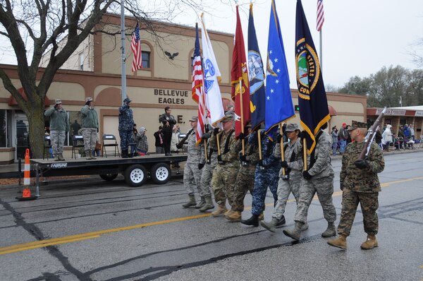 Senior leaders from U.S. Strategic Command (USSTRATCOM), the 55th Wing and the local community pay respects to the United States flag during the 2017 Bellevue Veterans Day Parade in Bellevue, Neb., Nov. 11, 2017. In addition to the parade, USSTRATCOM and 55th Wing leaders also participated in Veterans Day events at Memorial Park and the Eastern Nebraska Veterans Home to honor the service and sacrifice of American veterans and their families.