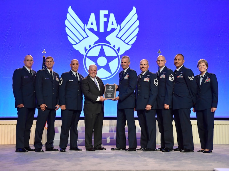 F. Whitten Peters, the Air Force Association chairman of the board, presents the AFA President’s Award to the 2016 Outstanding Reserve Aircrew of the year to Lt. Col. Luke Thompson, C-130 Hercules aircraft commander, and the aircrew of GLIDE 68, Sept. 18 at the AFA Air Space Cyber Conference held in National Harbor, Maryland.