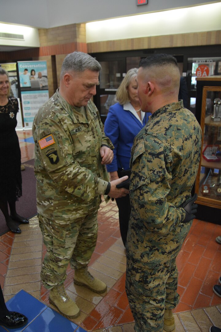 U.S. Army Chief of Staff Gen. Mark A. Milley presents his military coin to Marine Corp. Alexander Cruz while visiting Brooke Army Medical Center in honor of Veterans Day Nov. 11, 2017. Cruz has been undergoing physical therapy with the BAMC Burn Rehabilitation team.
