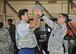 Tech. Sgt. Justin Williams, 445th Security Forces Squadron, helps a student don a kevlar helmet during the Dayton public schools outreach event the 445th Airlift Wing hosted Oct. 20, 2017.