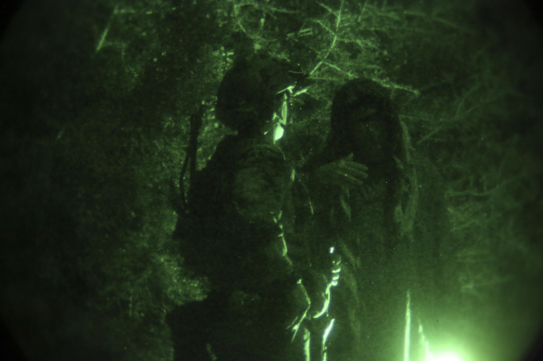 A critical skills operator with 1st Marine Raider Battalion, U.S. Marine Corps Forces, Special Operations Command, discusses simulated terrorist activity in the community with the mayor of the area during a Direct Action exercise in Picayune, Miss., Nov. 2, 2017.  Marines with 1st MRB participated in RAVEN 18-02, a 10-day realistic military training exercise designed to assess the Marine Special Operations Companies and Marine Special Operations Teams’ capability to effectively complete their missions.  RAVEN is the culminating exercise for MSOCs and subordinate MSOTs meant to enhance the battalion’s readiness for upcoming deployments.  (U.S. Marine Corps photo by Cpl. Bryann K. Whitley)