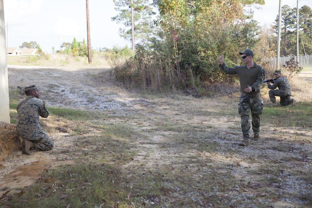 A critical skills operator with 1st Marine Raider Battalion, U.S. Marine Corps Forces, Special Operations Command, instructs Marines with Marine Air Control Group-28 and 2nd Marine Information Group on how to provide better cover during an operations in urban terrain training exercise in Hattiesburg, Miss., Nov. 6, 2017.  Marines with 1st MRB participated in RAVEN 18-02, a 10-day realistic military training exercise designed to assess the Marine Special Operations Companies and Marine Special Operations Teams’ capability to effectively complete their missions. Marines with MACG-28 and 2nd MIG played the role of partner nation forces during the exercise.   (U.S. Marine Corps photo by Cpl. Bryann K. Whitley)