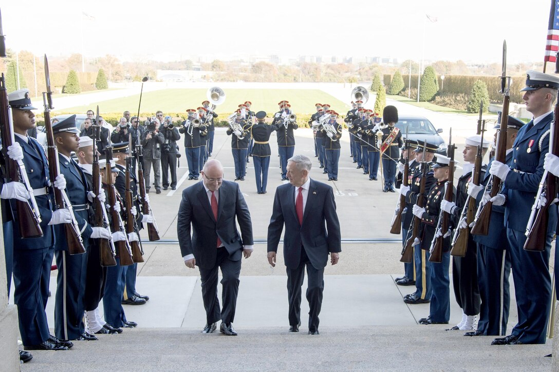 Defense Secretary Jim Mattis walks with the Georgian defense minister up steps.