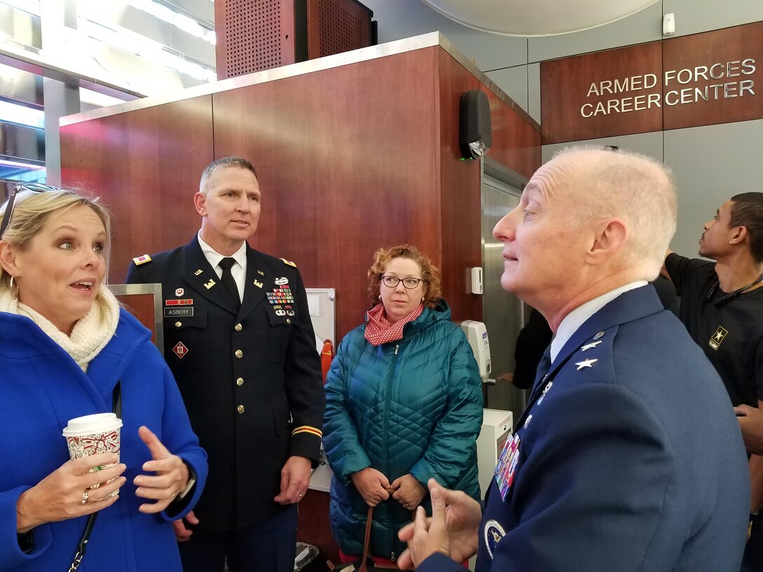 Colonel Thomas Asbery (middle) Commander, New York District, and esteemed guests speak with Major General Garrett Harencak, Commander, Air Force Recruiting Service, at the Times Square Recruiting Center in New York City.