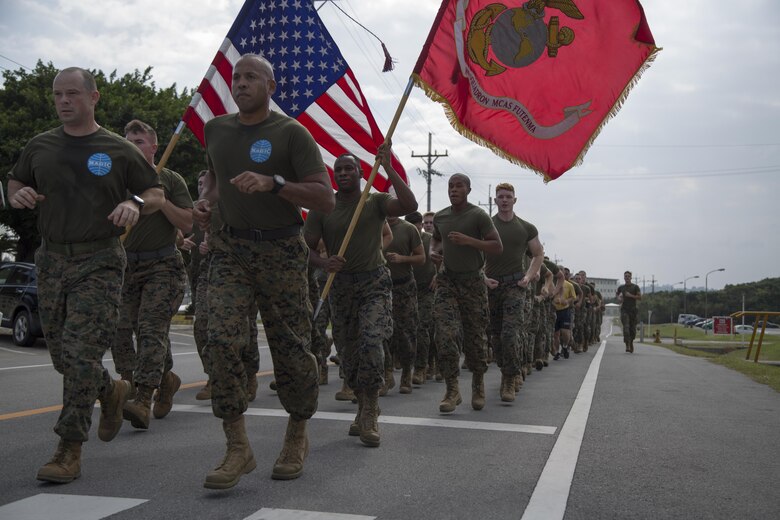 MCAS FUTENMA, OKINAWA, Japan— Marines and sailors run in formation during the 242-mile Birthday Run on Marine Corps Air Station Futenma, Okinawa, Japan.