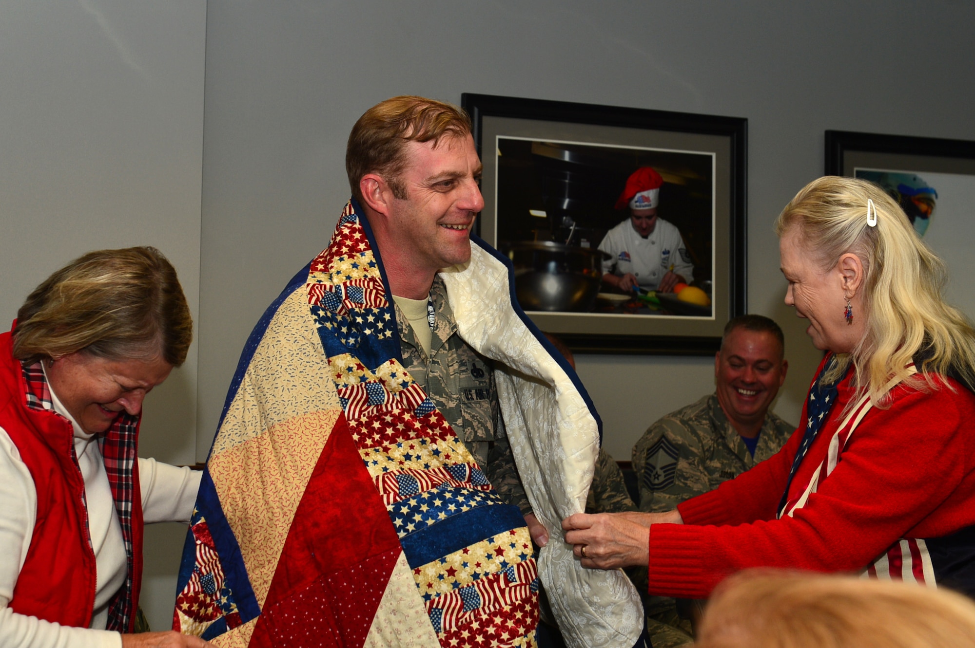 U.S. Air Force Senior Master Sgt. Daniel Henderson, 20th Aircraft Maintenance Squadron, 55th Aircraft Maintenance Unit, assistant superintendent, shares a laugh with Quilts of Valor Foundation (QOVF) members during a QOVF event at Shaw Air Force Base, South Carolina, Nov. 9, 2017.