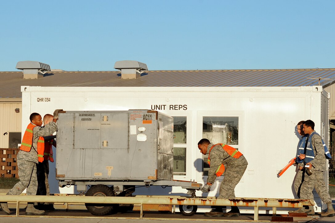 U.S. Airmen assigned to the 20th Fighter Wing move cargo onto a scale at Shaw Air Force Base, South Carolina, Oct. 24, 2017.