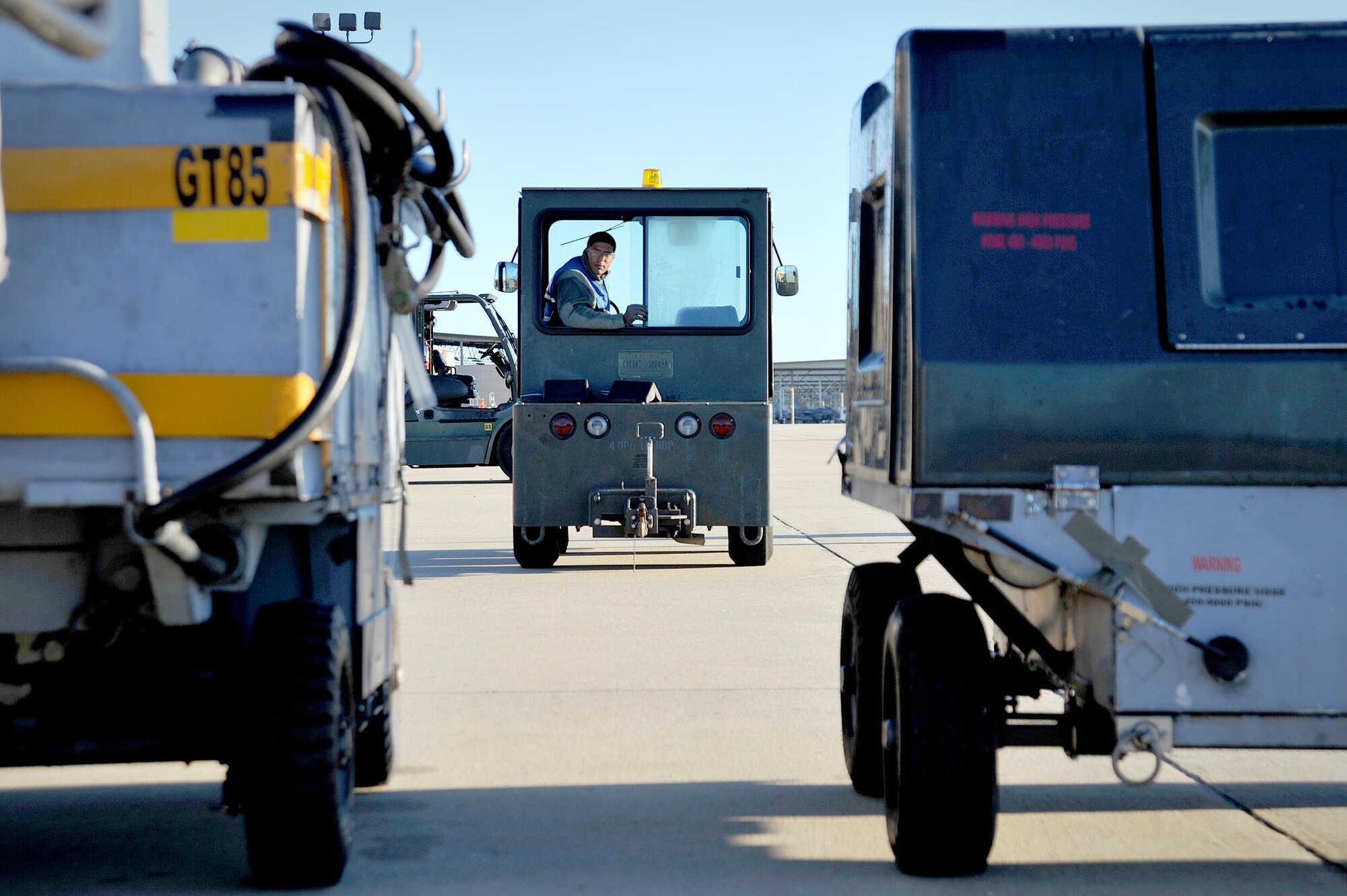 U.S. Air Force Senior Airman Eric Harvey, 20th Logistics Readiness Squadron air transportation augmentee, backs up a shop tug at Shaw Air Force Base, South Carolina, Oct. 24, 2017.