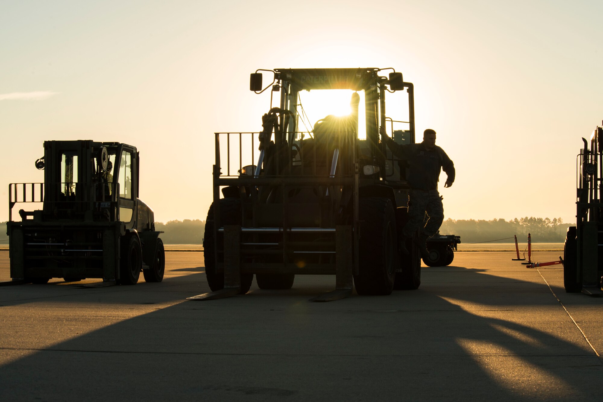 A U.S. Airman climbs out of a forklift on the flightline of Shaw Air Force Base, South Carolina, Nov. 1, 2017.