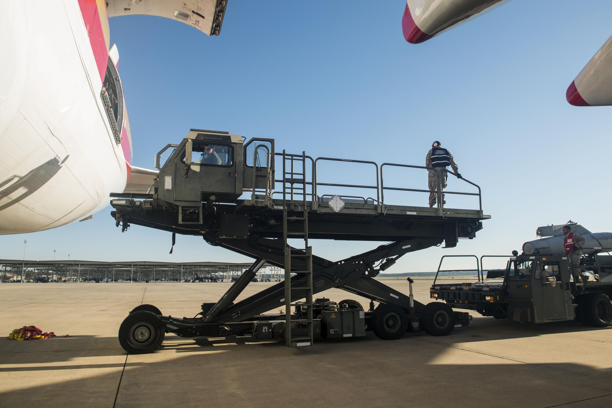 U.S. Airmen assigned to the 20th Logistics Readiness Squadron (LRS) lower a k-loader bed to reload a vehicle at Shaw Air Force Base, South Carolina, Nov. 1, 2017.