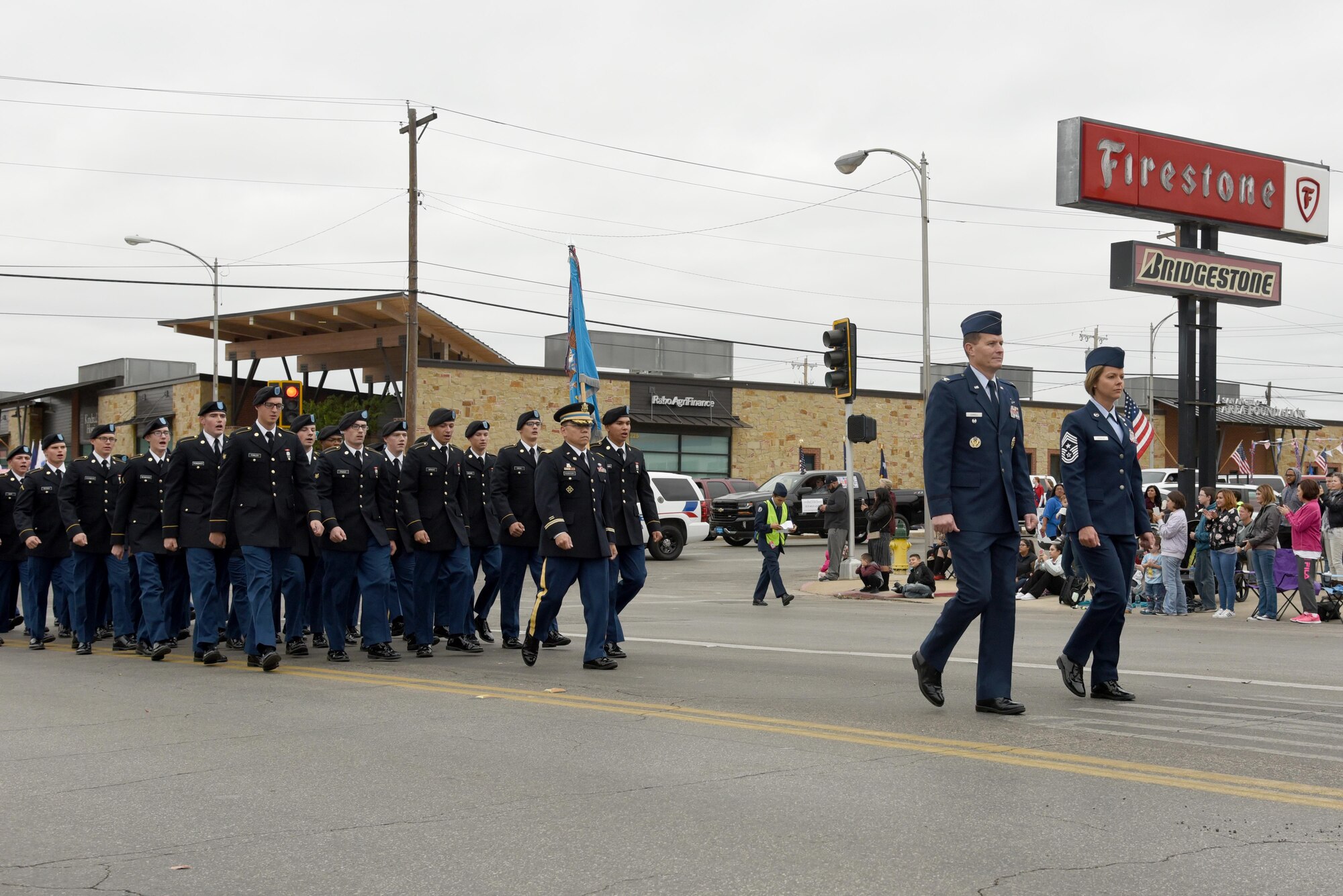 U.S. Air Force Col. Jeffrey Sorrell, 17th Training Wing vice commander, and Chief Master Sgt. Bobbie Riensche, 17th Training Wing command chief, lead the Goodfellow formations beginning with U.S. Army Lt. Col. Yukio Kuniyuki, 344th Military Intelligence Battalion commander, and his battalion in San Angelo’s Veteran’s Day Parade Nov. 11, 2017, San Angelo, Texas.