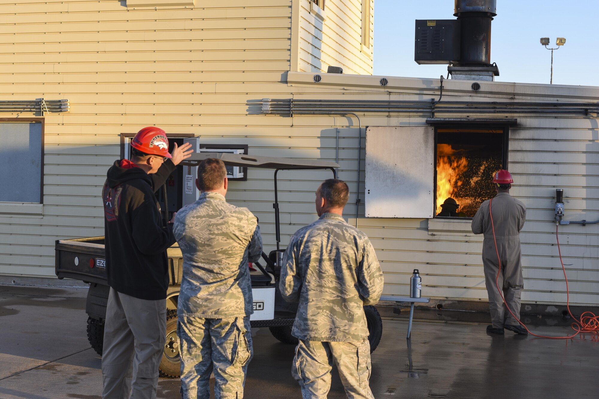 U.S. Air Force Staff Sgt. Tanner Derosier, 312 Training Squadron instructor, explains a demonstration to Maj. Gen. Timothy Leahy, 2nd Air Force commander and Lt. Col. Scott Cline, 312th Training Squadron commander, at the Louis F. Garland Department of Defense Fire Academy on Goodfellow Air Force Base, Texas, Nov. 2, 2017.  Trainees are put through a controlled fire so that they get the experience they need to save lives. (U.S. Air Force photos by Airman 1st Class Zachary Chapman/Released)
