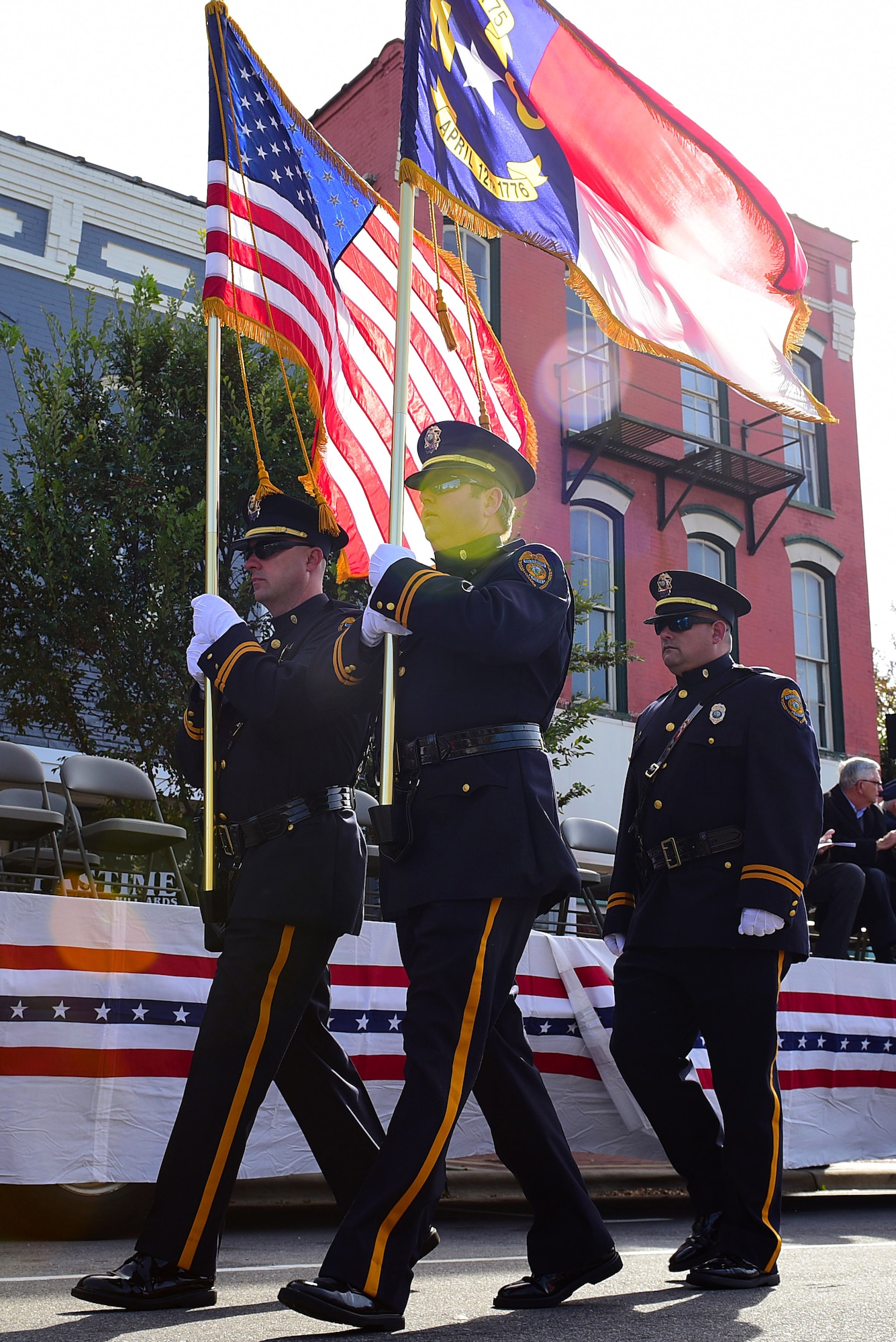 Three members of the Goldsboro Police Department march after presenting the colors to signify the start of the Wayne County Veterans Day Parade, Nov. 11, 2017, in Goldsboro, North Carolina. Goldsboro PD presented the colors alongside the Wayne County Sheriff’s Office while Airman 1st Class Christopher Echevarria Arroyo, 4th Component Maintenance Squadron avionics apprentice, sang the national anthem. (U.S. Air Force photo by Airman 1st Class Kenneth Boyton)