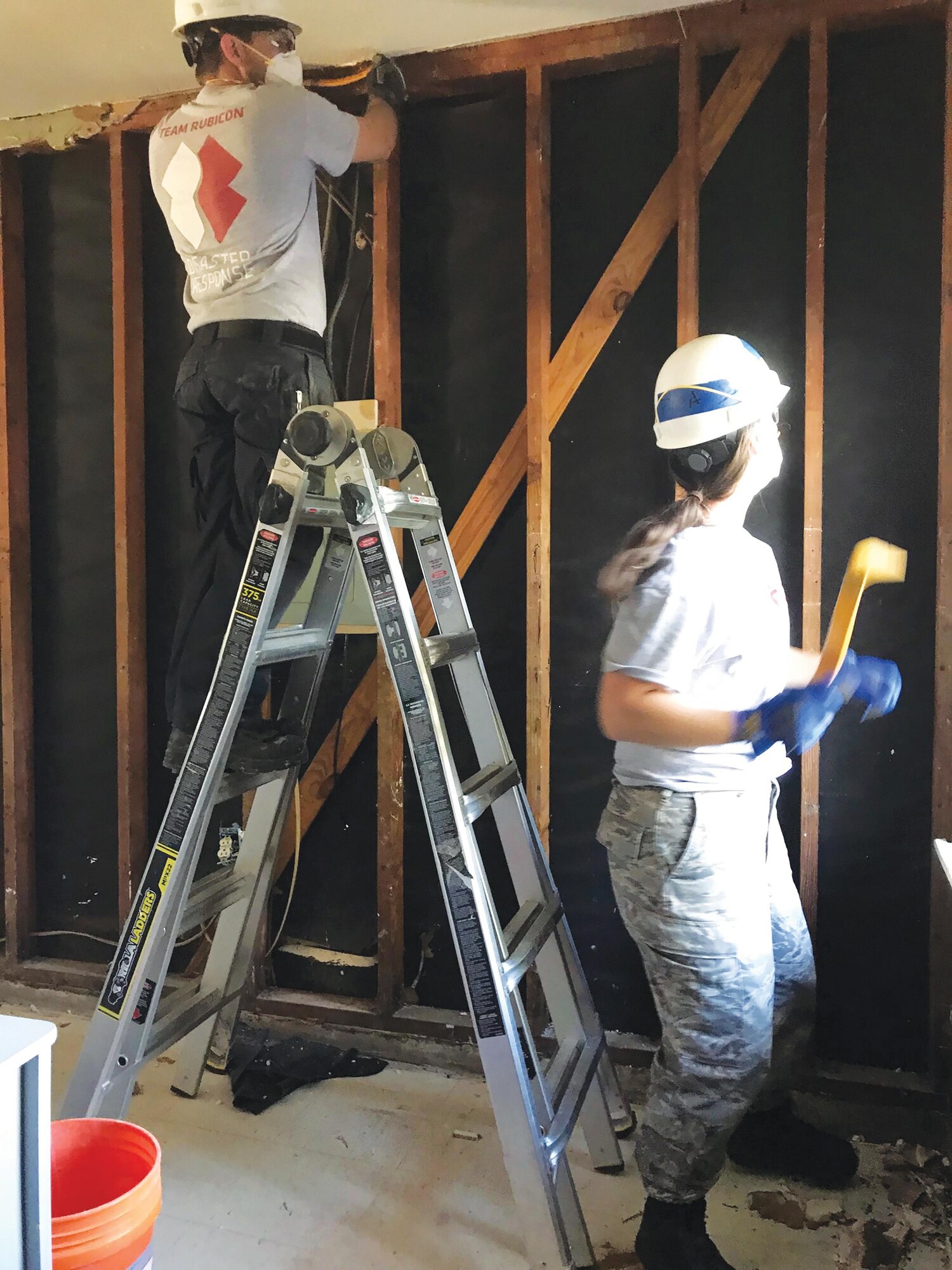 Tech. Sgt. Cody Smeltzer, 445th Aerospace Medicine Squadron, and Jennifer Bentley, a fellow Team Rubicon volunteer, gut a room that once contained more than two feet of water as a result of Hurricane Harvey.