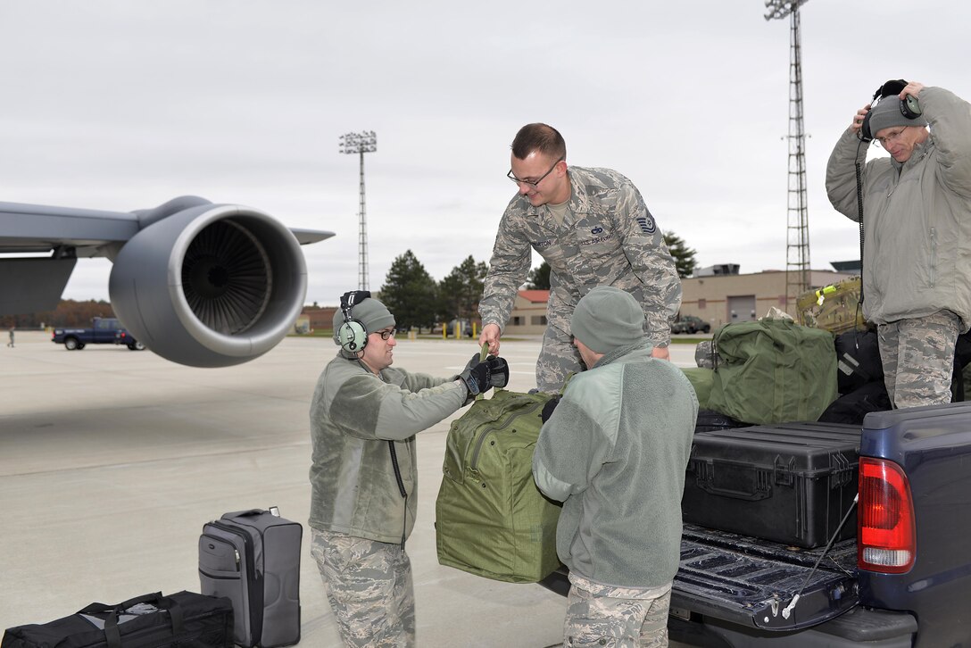 Members of the 157th Air Refueling Wing Aircraft Maintenance Squadron help load baggage onto a KC-135 Stratotanker prior to the departure of twelve airman from the 260th Air Traffic Control Squadron deploying in support of hurricane relief efforts in Puerto Rico on November 13, 2017, at Pease Air National Guard Base, N.H. They will join Airman from the 235th ATCS, North Carolina Air National Guard and augment the air control efforts at an airfield. (N.H. Air National Guard photo by Master Sgt. Thomas Johnson)