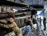 Tennessee National Guard Soldiers push a UH-60 Black Hawk into a C-17 aircraft carrier Sept. 13 at Joint Base Berry Field, Nashville, Tenn.