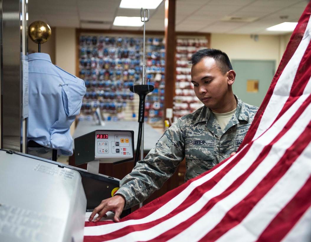 Air Force Senior Airman John Paul Javier presses the U.S. flag for use during mortuary affairs operations at Dover Air Force Base, Del., Oct. 24, 2017. Army photo by Master Sgt. Brian Hamilton