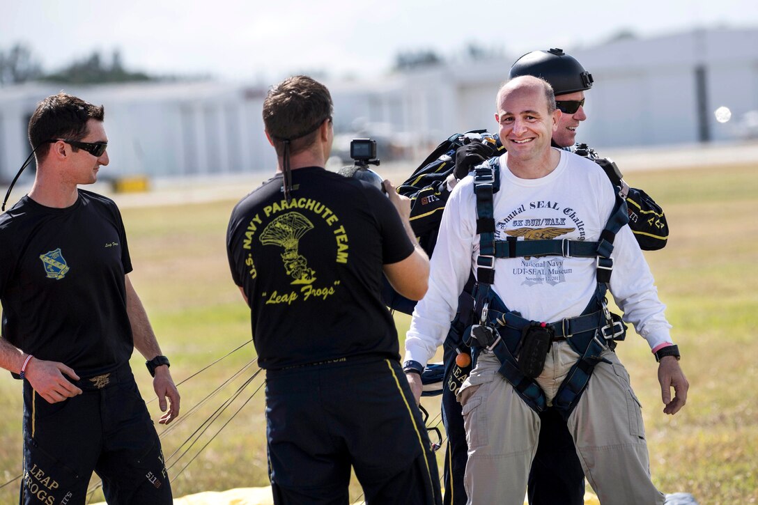 Troy McDonald, right, mayor of Stuart, Fla., talks about his experience after performing a tandem airborne jump with retired Navy SEAL Jim Woods, a member of the U.S. Navy Parachute Team, the Leap Frogs.