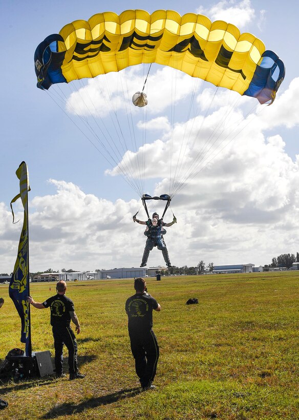Congressman Brian Mast, U.S. representative for Florida’s 18th congressional district, and retired Navy SEAL Jim Woods, a member of the U.S. Navy parachute team, the Leap Frogs, prepare to land