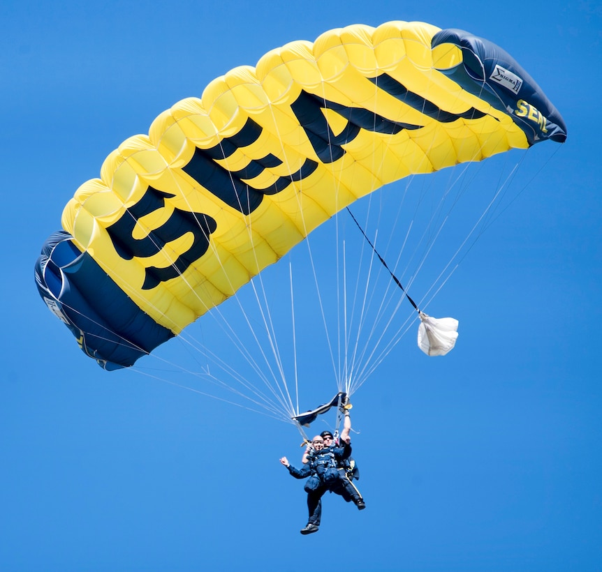 Congressman Brian Mast, Florida’s 18th congressional district, parachutes tandem with retired Navy SEAL Jim Woods, a member of the U.S. Navy Parachute Team.