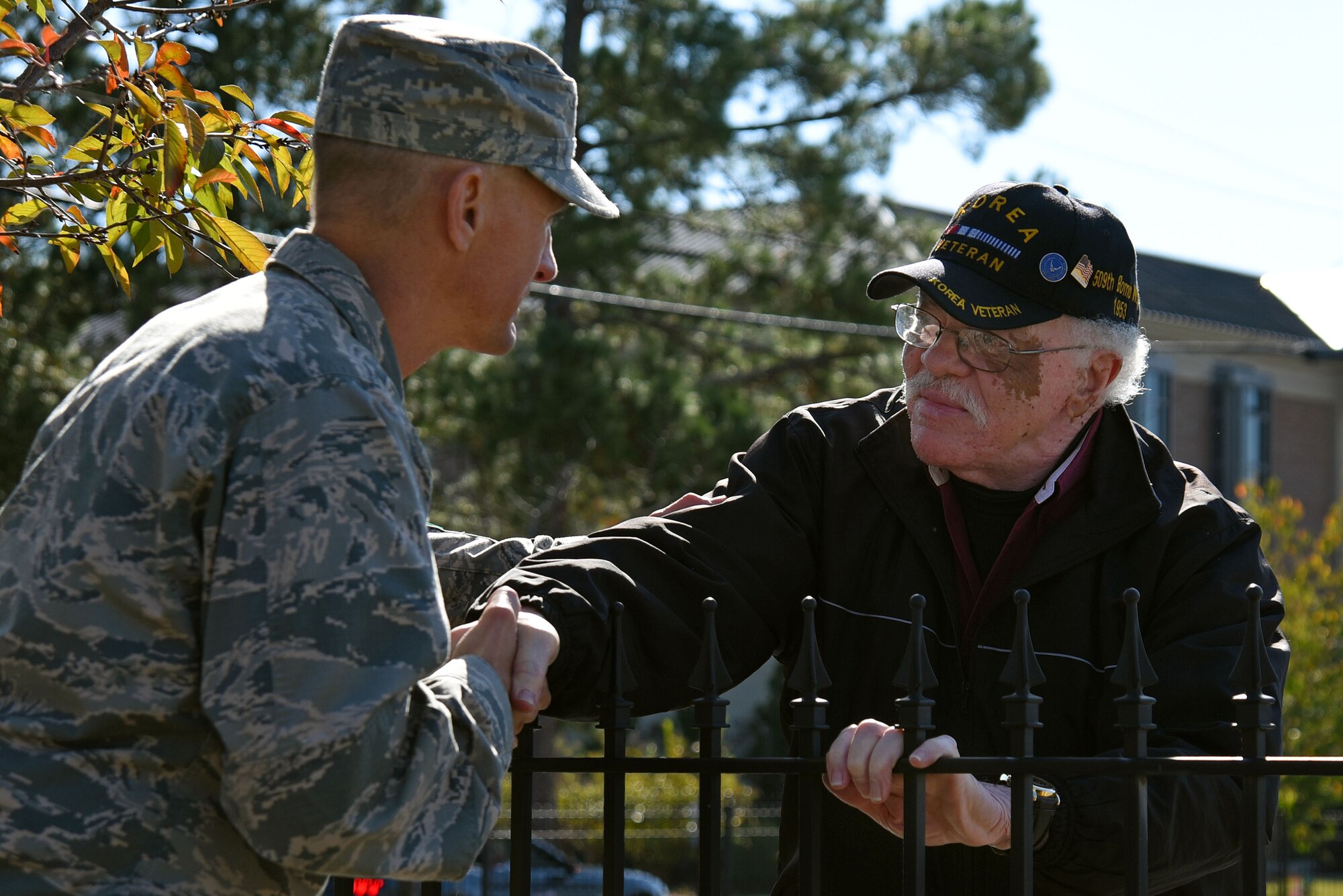 U.S. Air Force Col. Daniel Lasica, 20th Fighter Wing commander, left, shakes the hand of a veteran during a Veterans Day Celebration parade in Sumter, South Carolina, Nov. 11, 2017.