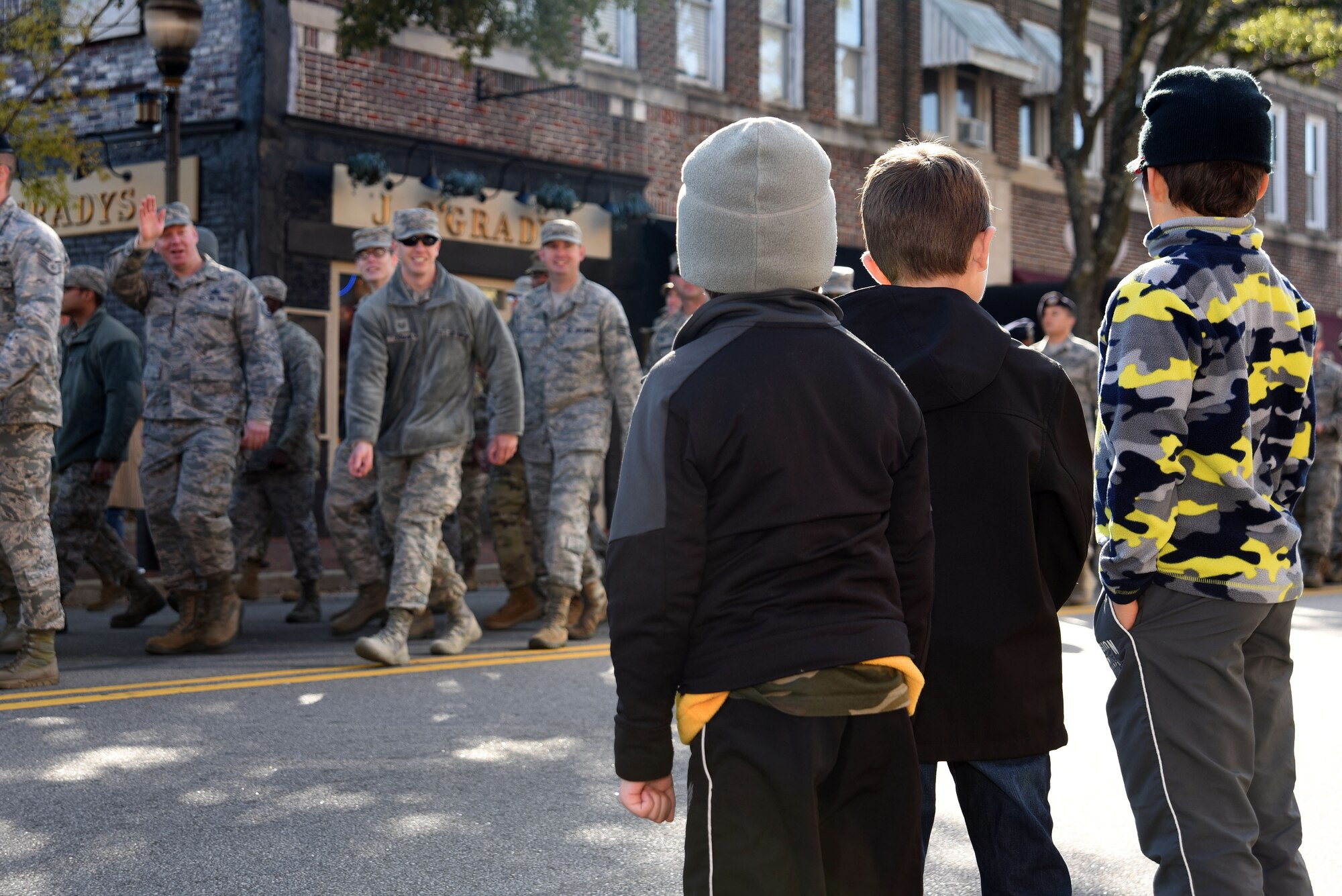 Children watch as U.S. Airmen and Soldiers walk past during a Veterans Day Celebration parade in Sumter, South Carolina, Nov. 11, 2017.