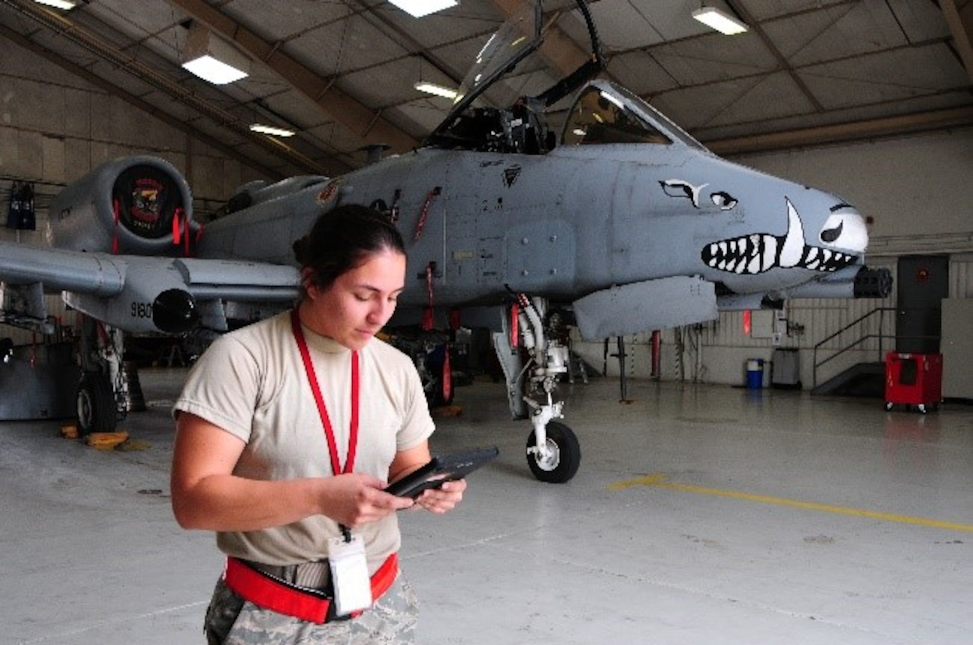 Senior Airman Amanda Gonzales, 924th Fighter Group crew chief, checks her technical orders before beginning maintenance on an A-10 Thunderbolt II in a hangar on Davis-Monthan Air Force Base.