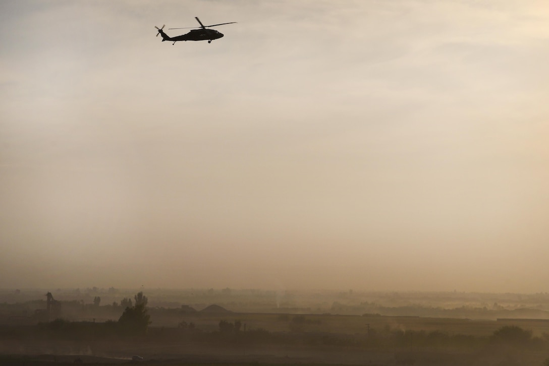 Army pilots fly a UH-60 Black Hawk helicopter transporting soldiers and supplies to multiple locations.