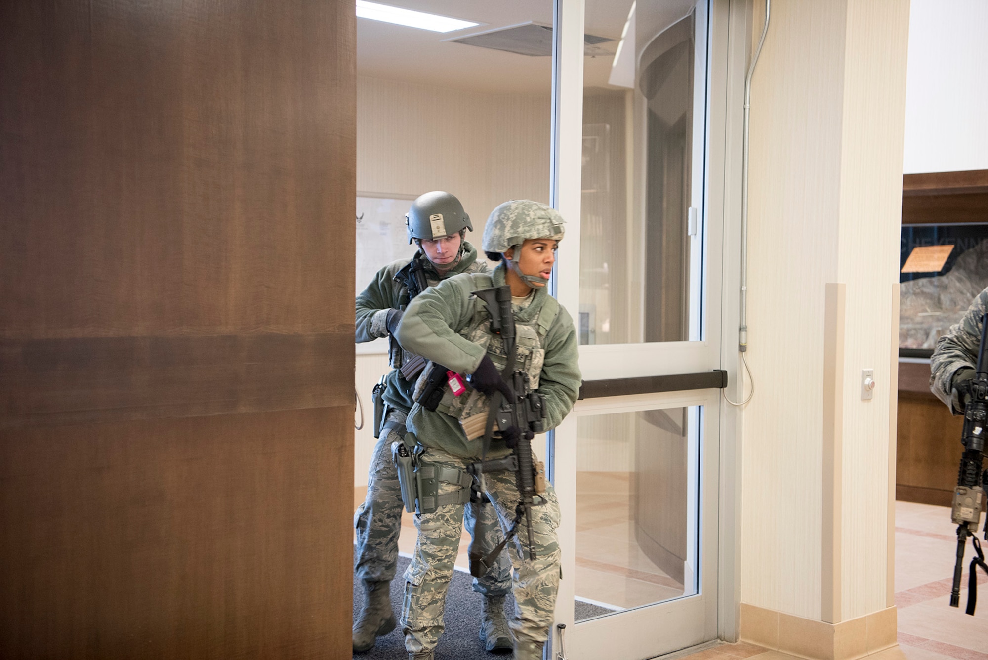 Airman 1st Class Leah Yonker, 721st Security Forces Squadron, member, enters the building in which an acting suspected shooter is during an exercise at Cheyenne Mountain Air Force Station, Colorado, Nov. 8, 2017. The active shooter training was conducted as part of exercise Condor Crest, a week long test of the readiness of the 21st Space Wing units.  (U.S. Air Force photo by Steve Kotecki)