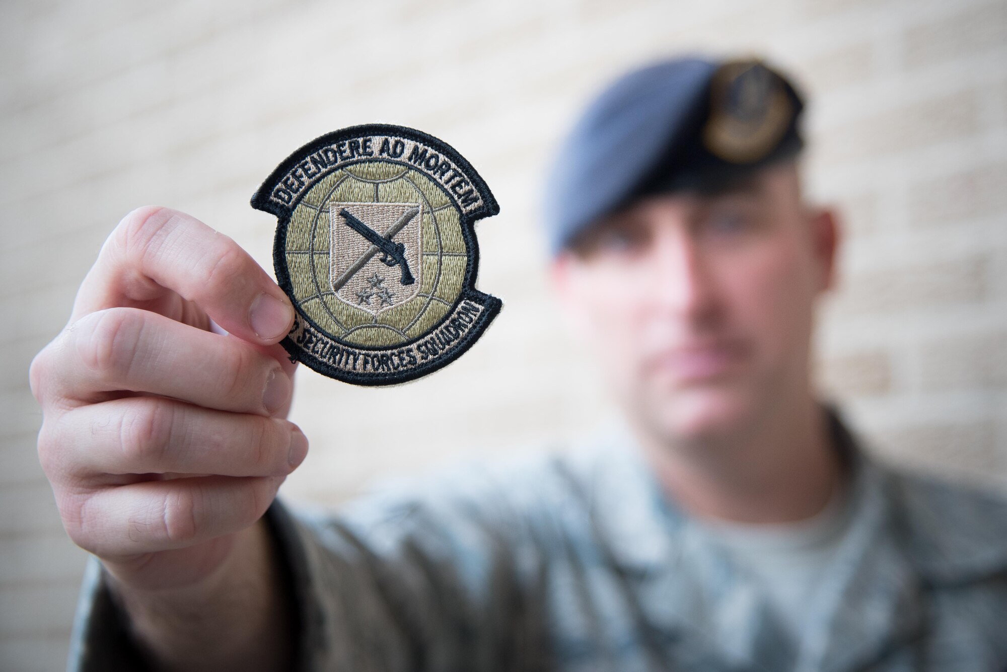 Master Sgt. Lucas Applewhite, 403rd Security Forces Squadron action officer, displays the new 403rd SFS unit patch Nov. 7, 2017 at Keesler Air Force Base, Mississippi. (U.S. Air Force photo by Staff Sgt. Heather Heiney)