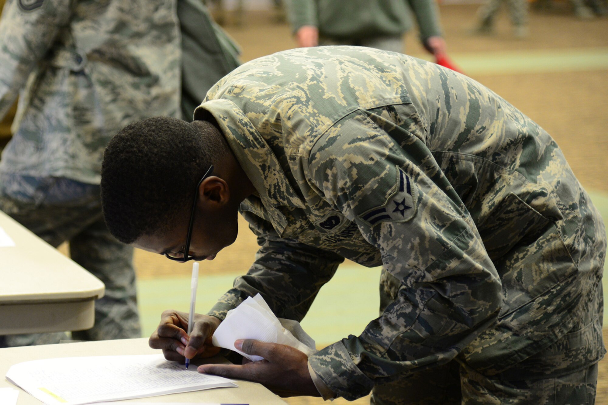 An Airman at the Combined Federal Campaign ceremony signs up to participate in the kickoff Nov. 14, 2017, at Malmstrom Air Force Base, Mont. The goal of the ceremony was to provide complete contact between individuals and organizations. (U.S. Air Force Photo by Airman 1st Class Tristan Truesdell)